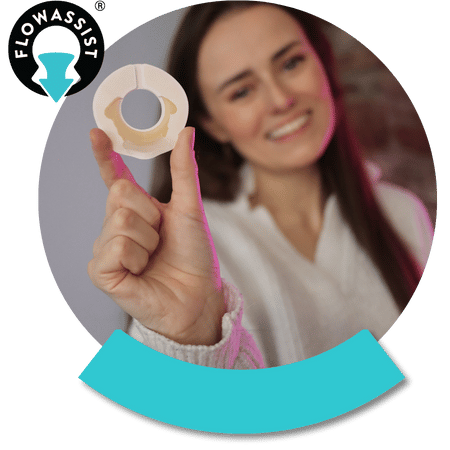 lady holding smiling and holding the flowassist seal towards the camera